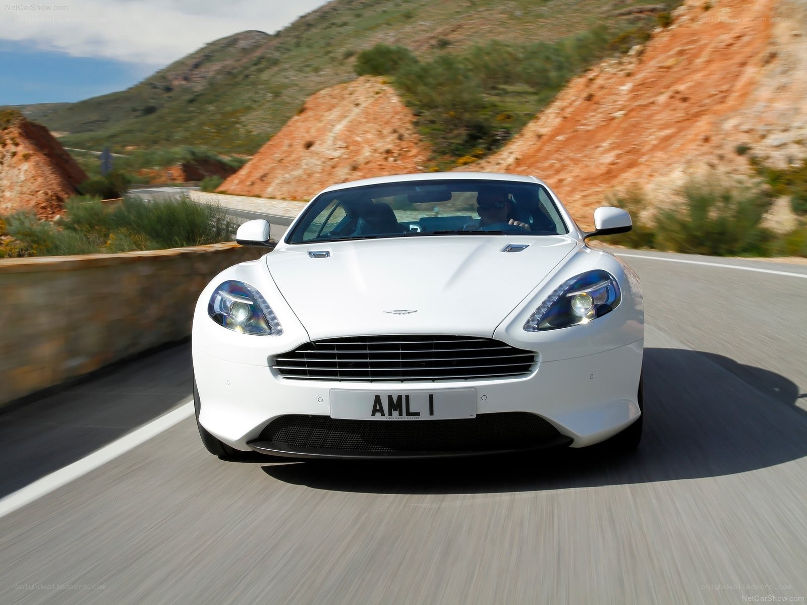 White Aston driving on a road