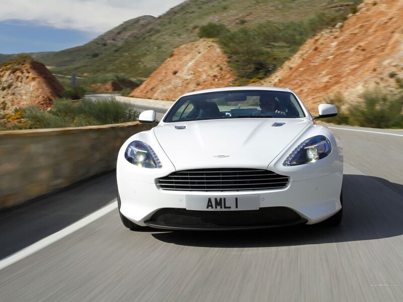 white aston martin driving on road