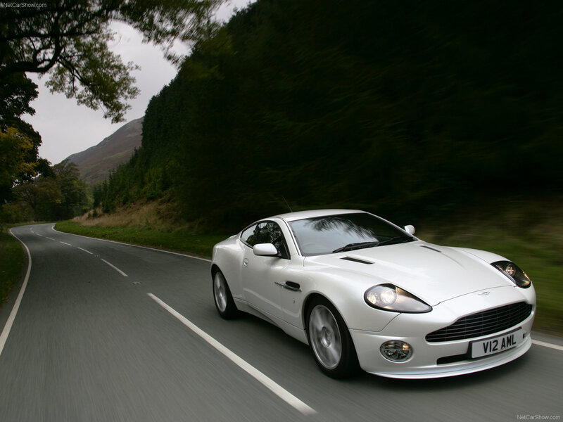 white aston martin driving on road