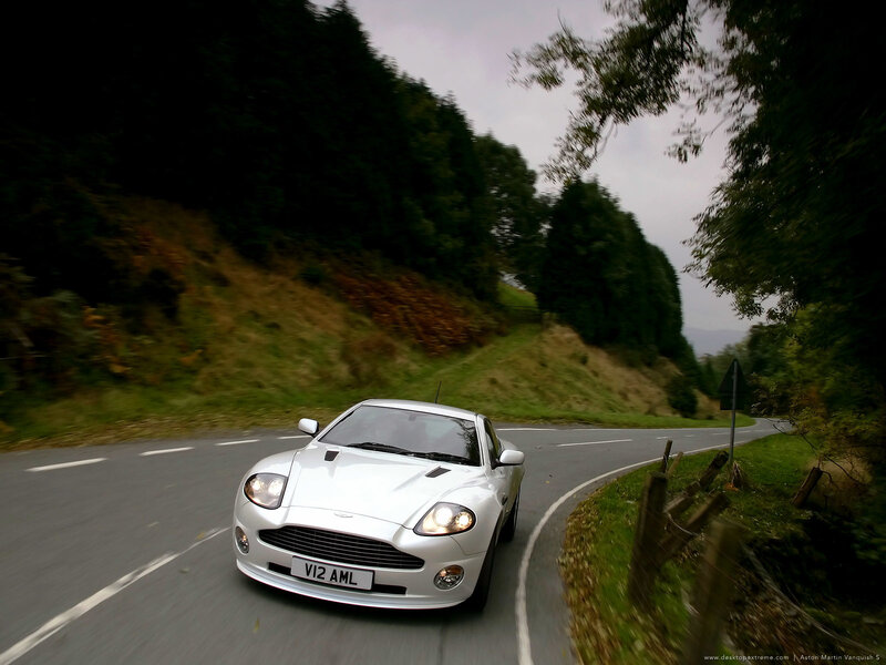 White Aston Martin on a winding road