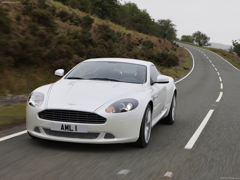 White Aston Martin on a winding road