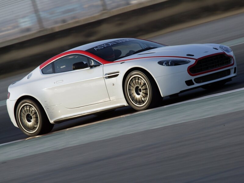 white aston martin on racetrack