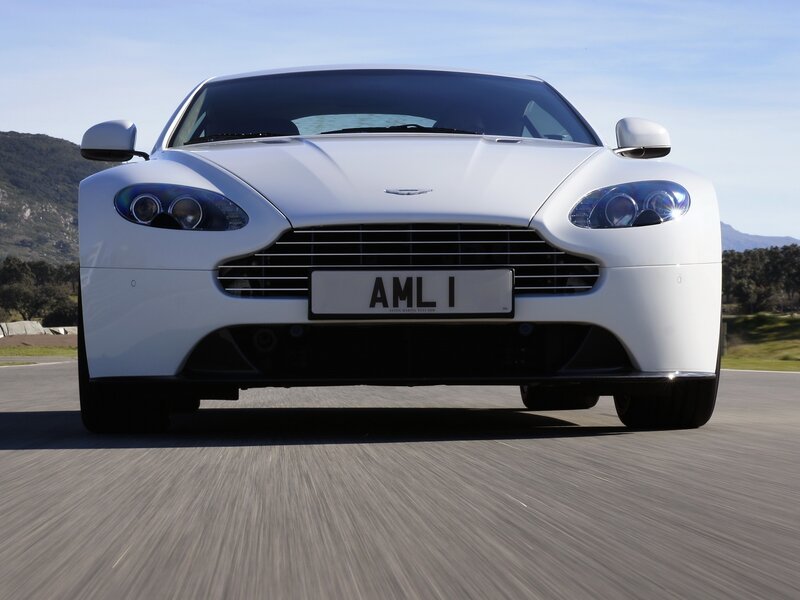 White Aston sports car on track