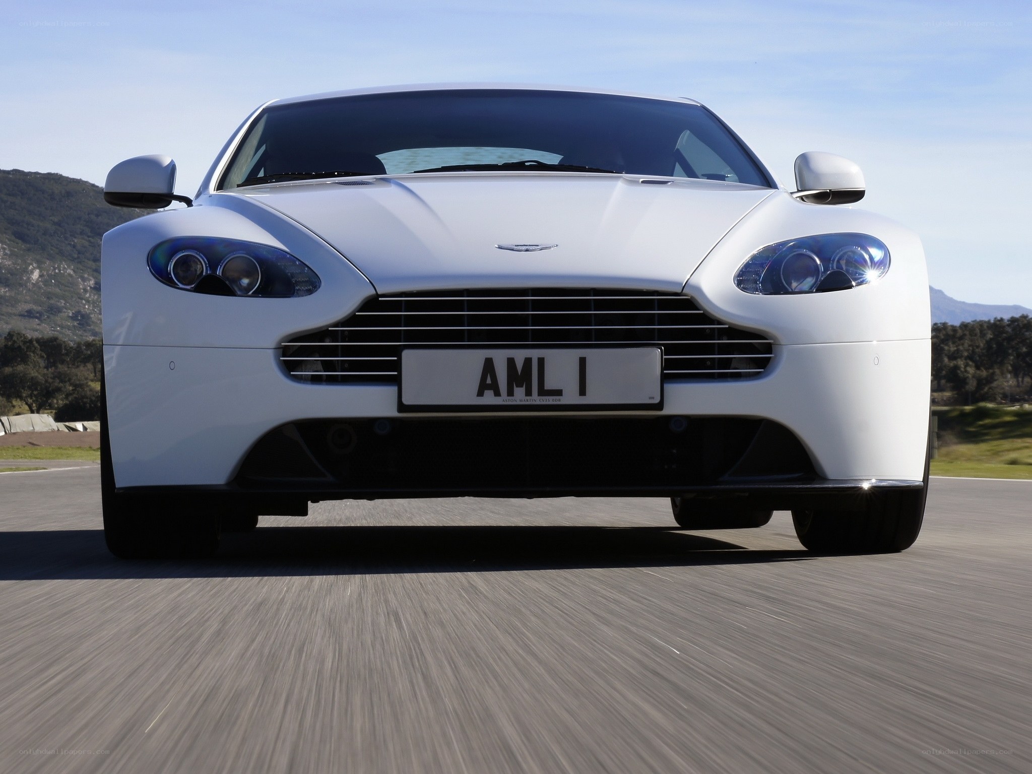 White Aston sports car on track