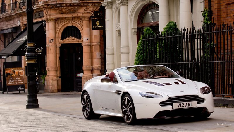 White Aston V12 convertible on street