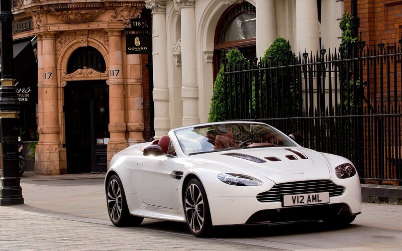 White Aston V12 convertible on street