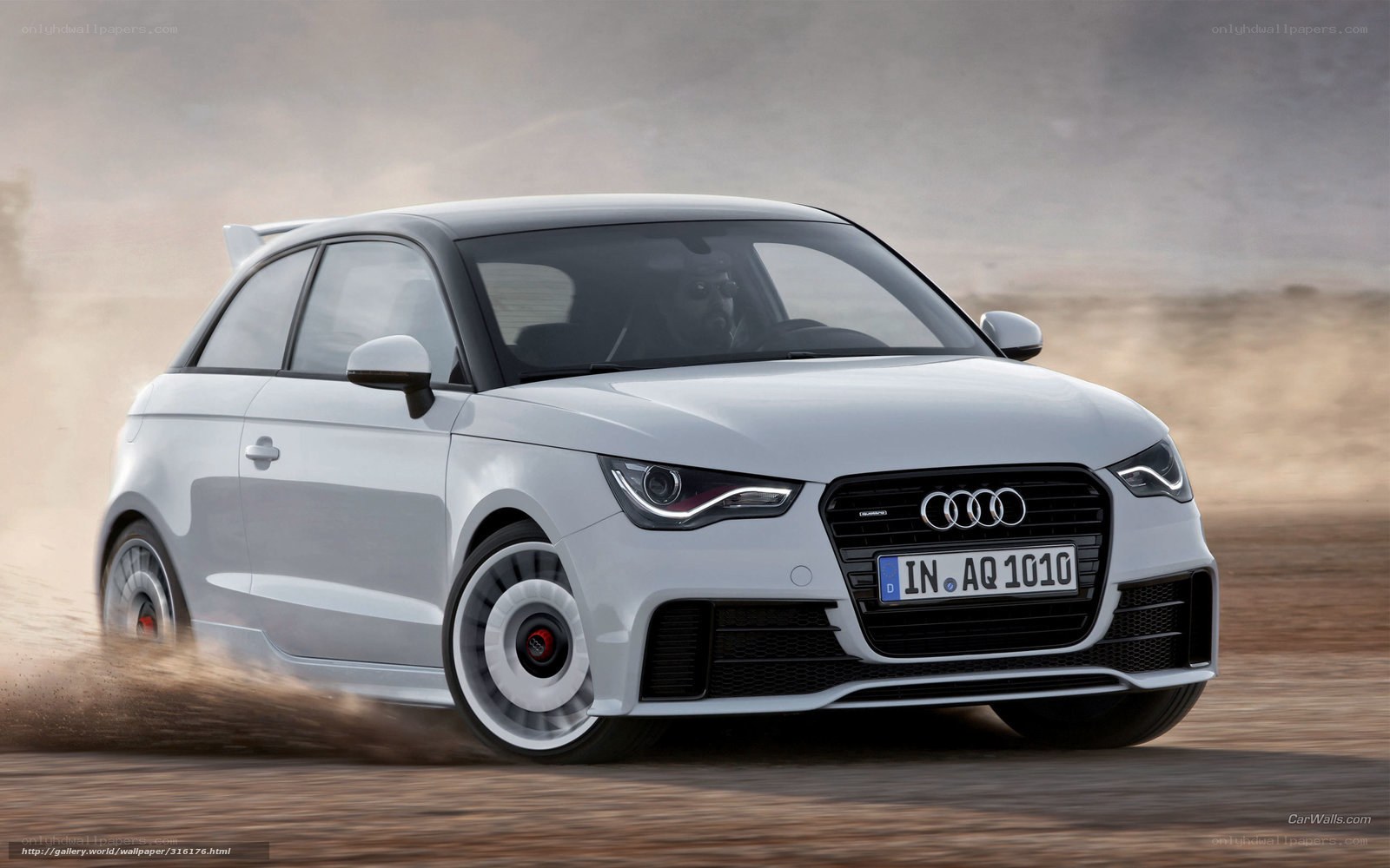 White Audi A1 driving on dirt