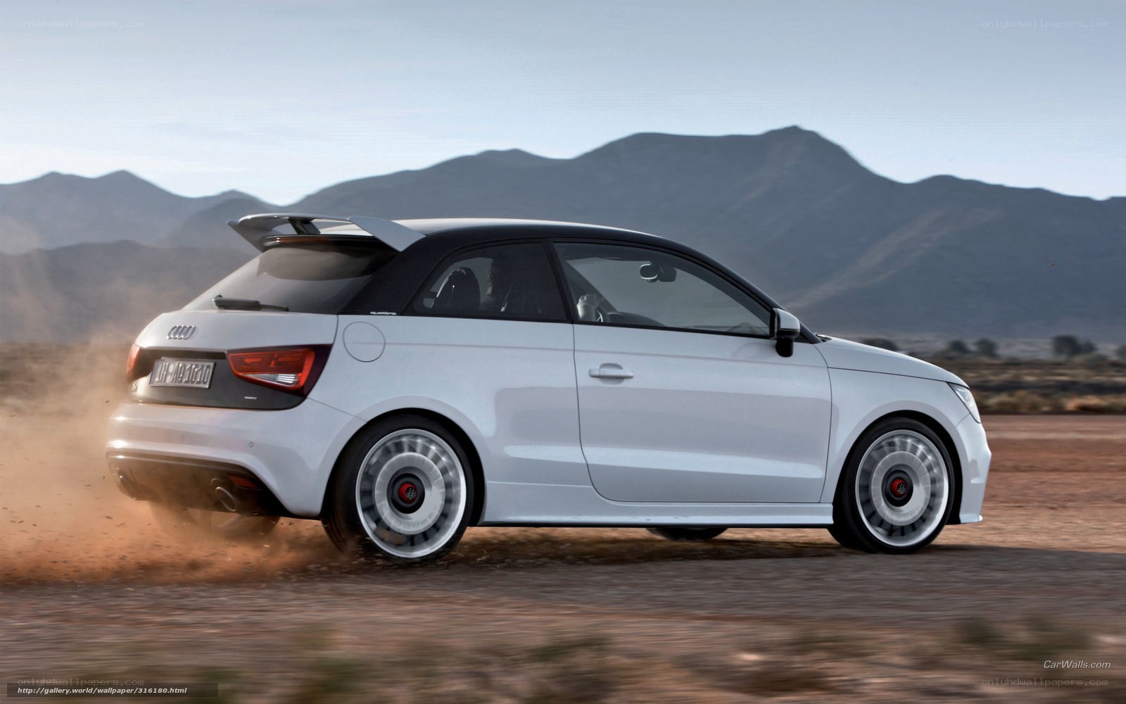 White Audi A1 driving on dirt