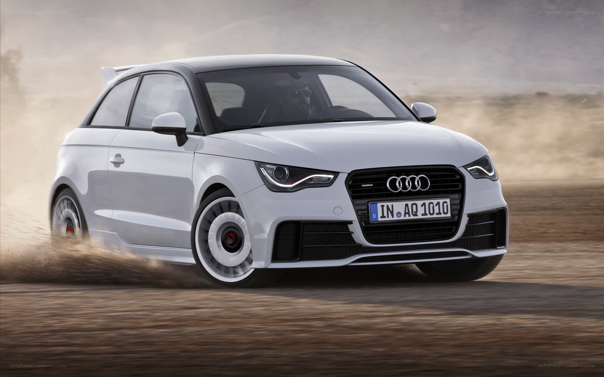 White Audi A1 driving on dirt