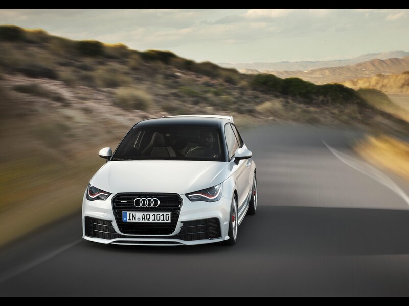 White Audi A1 driving on road