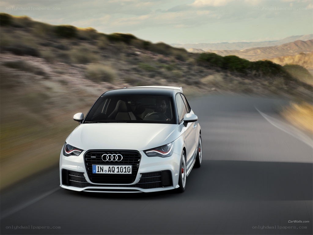 White Audi A1 driving on road