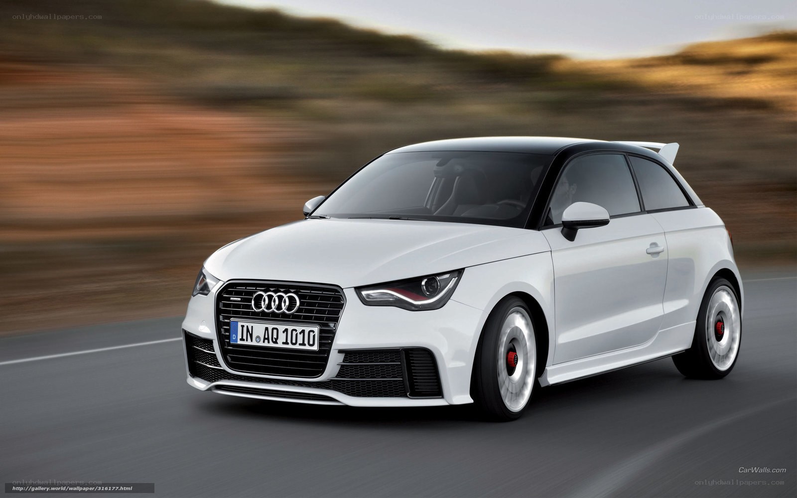 White Audi A1 driving on road