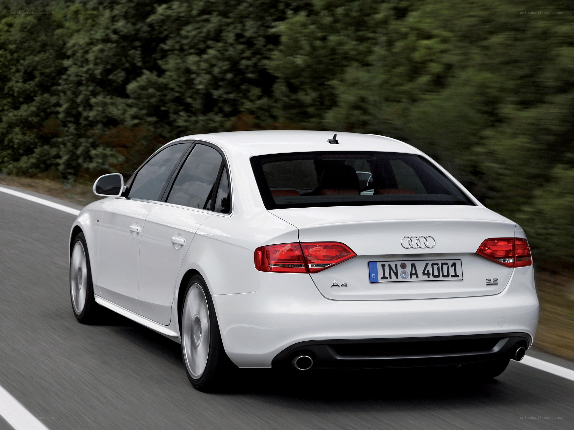 white audi a4 driving on road
