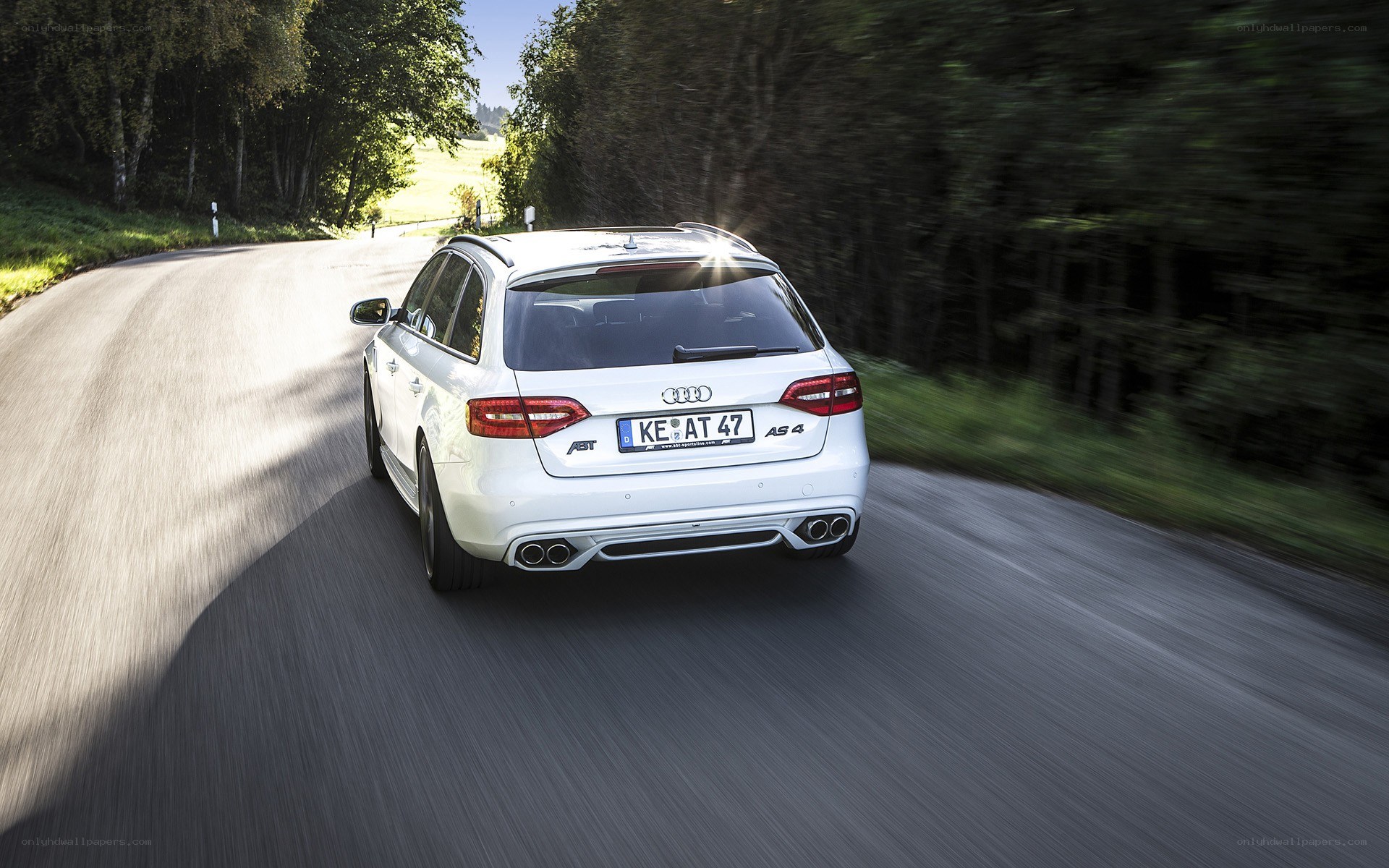 White Audi A5 driving on a road