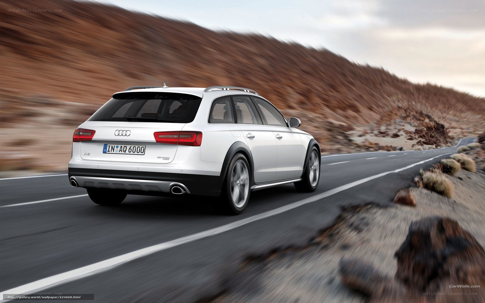 White Audi A6 allroad driving