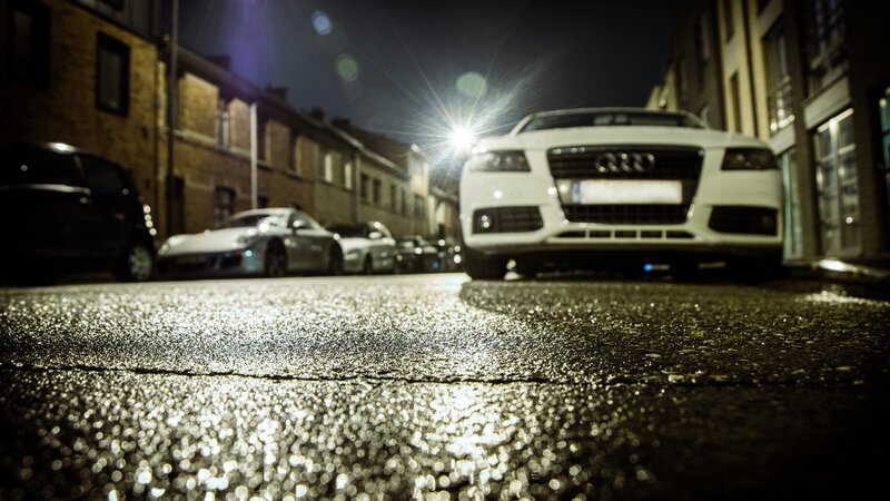 White Audi at night on wet street