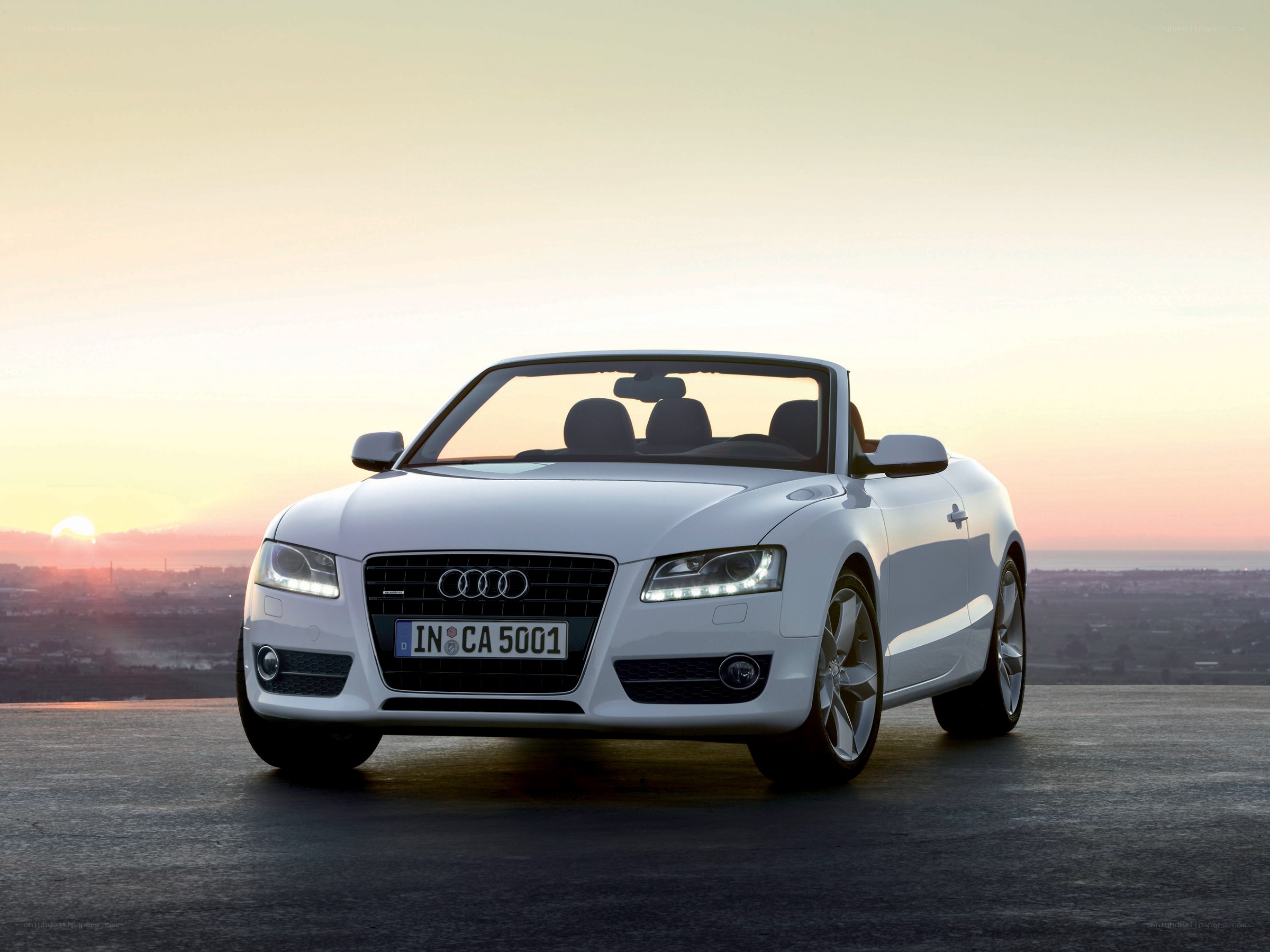White Audi convertible at sunset