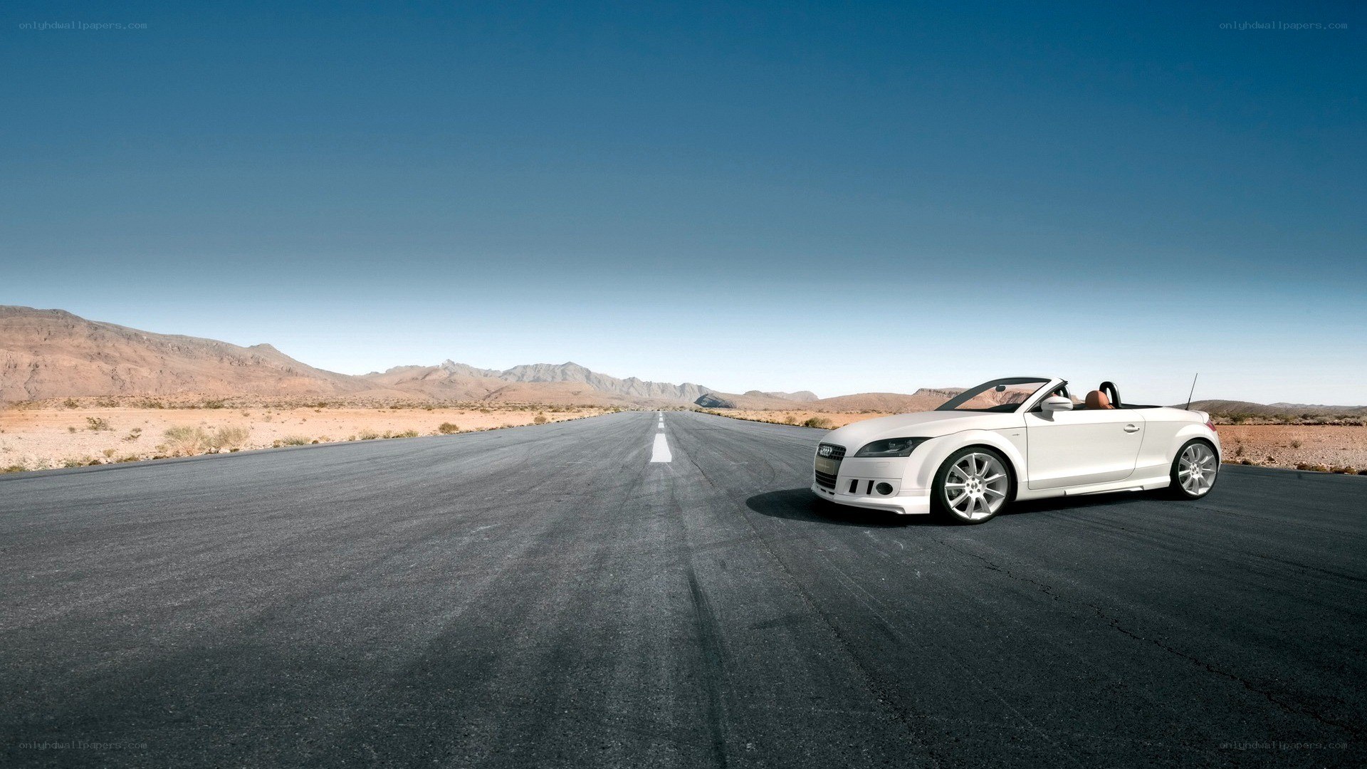 White Audi convertible on desert road