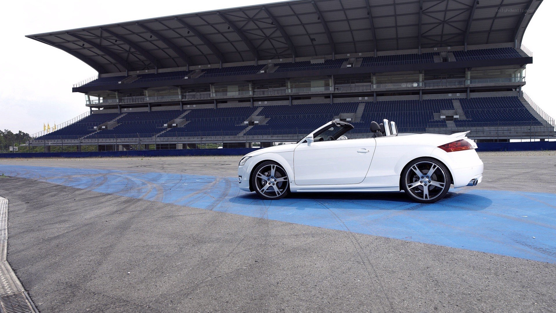 White Audi convertible on racetrack
