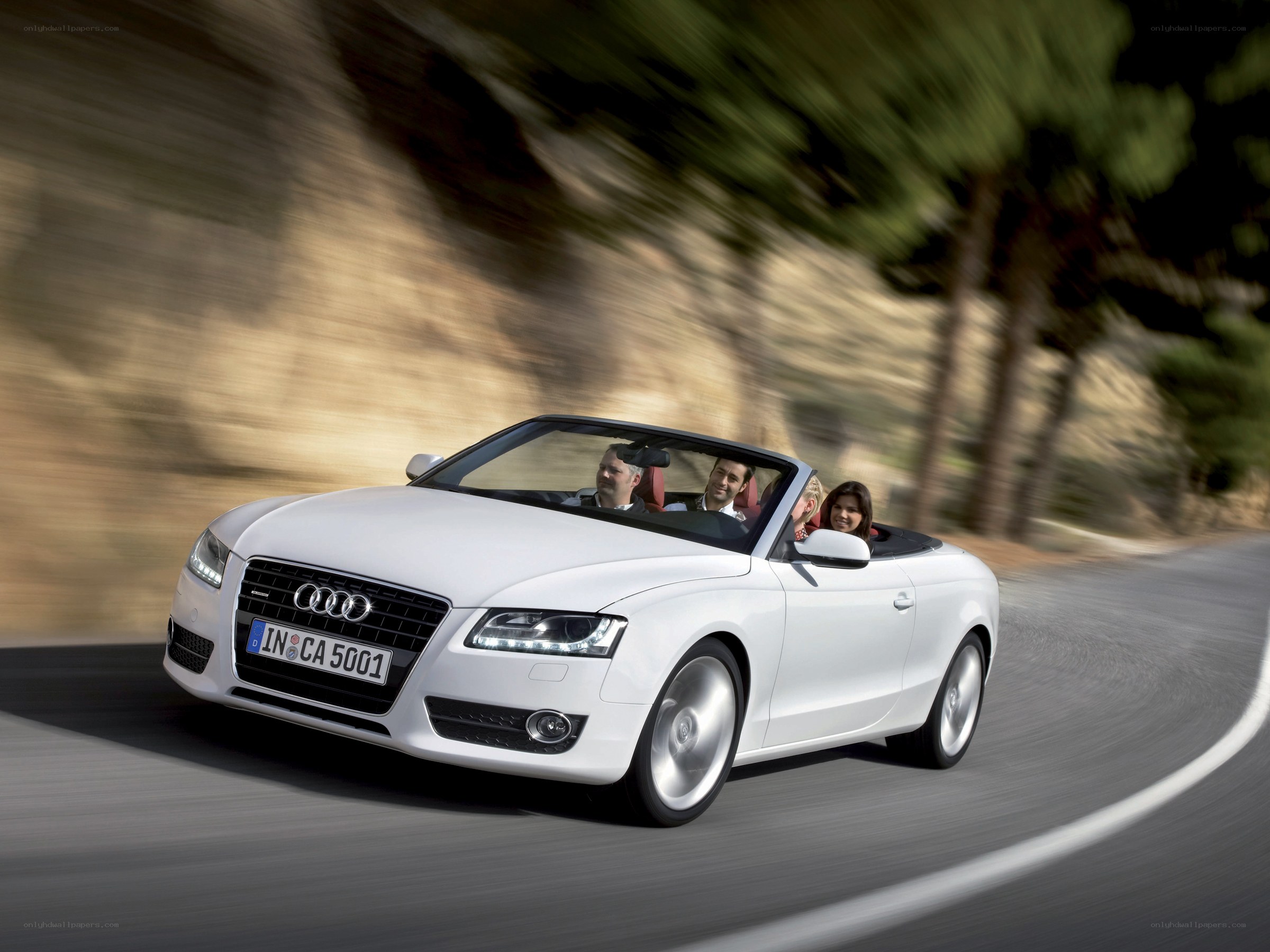 White Audi convertible on road