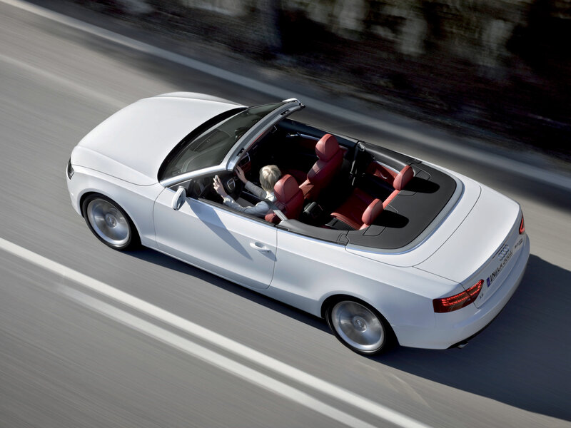 White Audi convertible on road