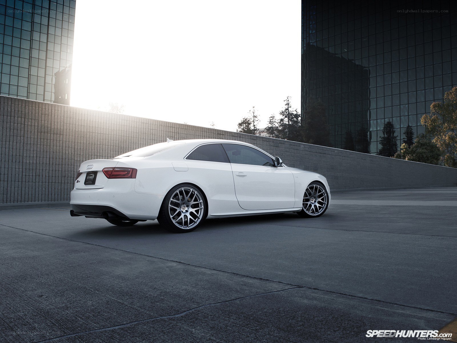 White Audi coupe in urban setting