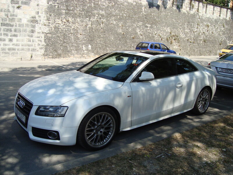 White Audi coupe parked on street