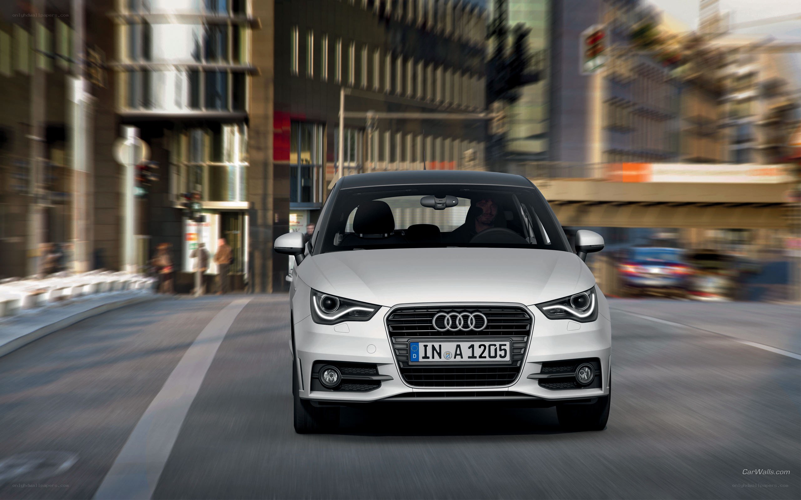 White Audi driving in city