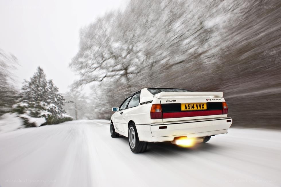White Audi driving in snow