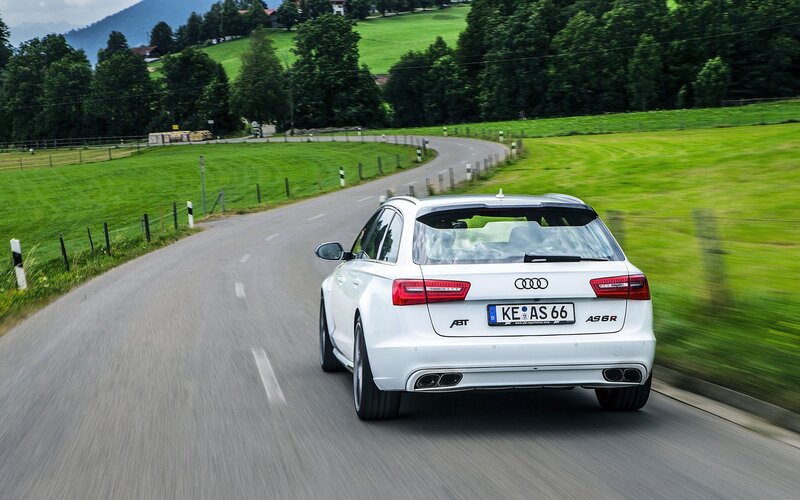 White Audi driving on a country road