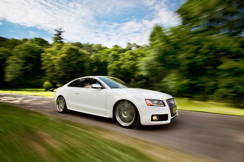 White Audi driving on a road