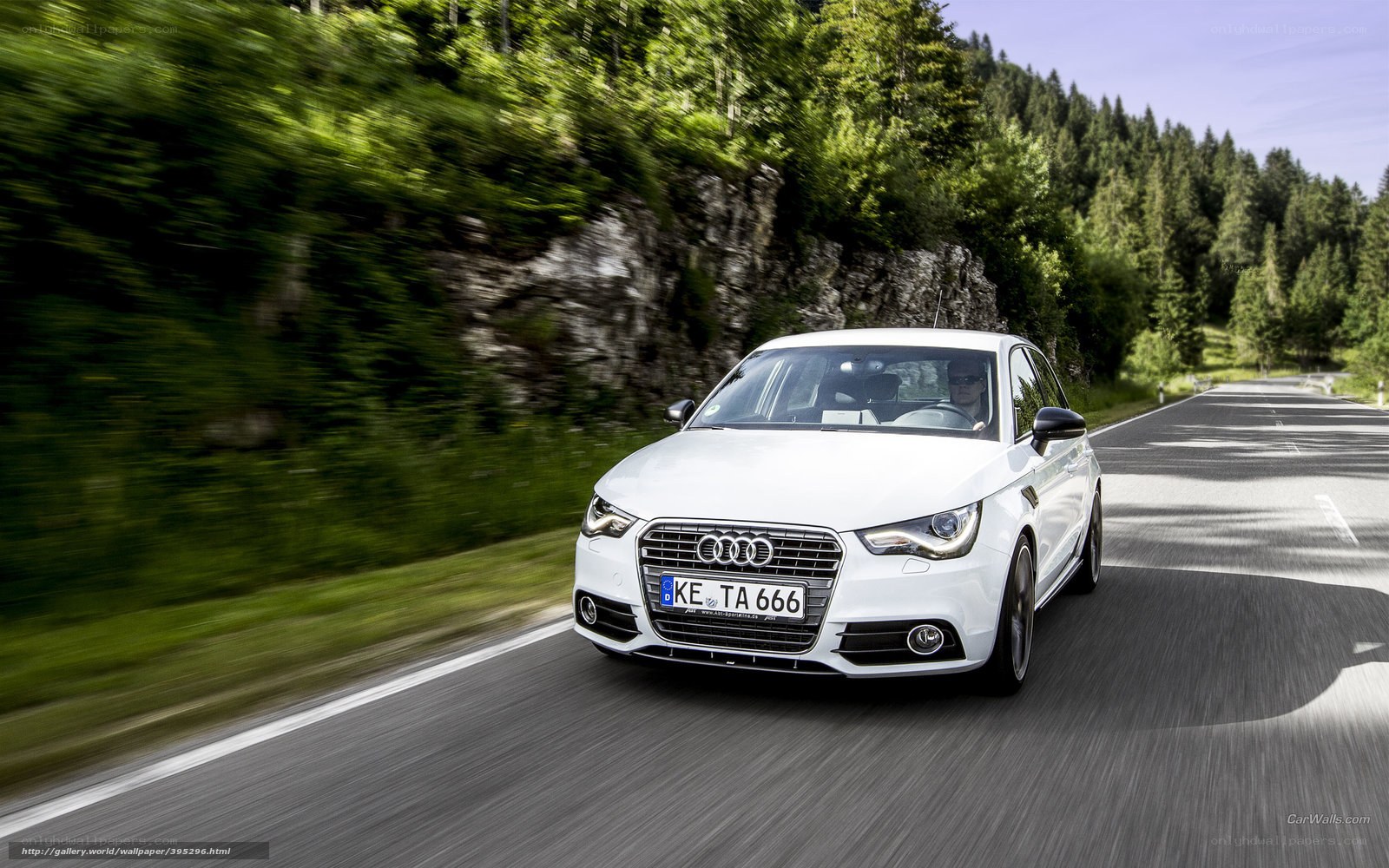 White Audi driving on a road