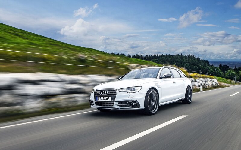 White Audi driving on a scenic road