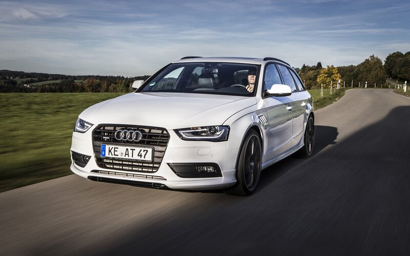White Audi driving on country road