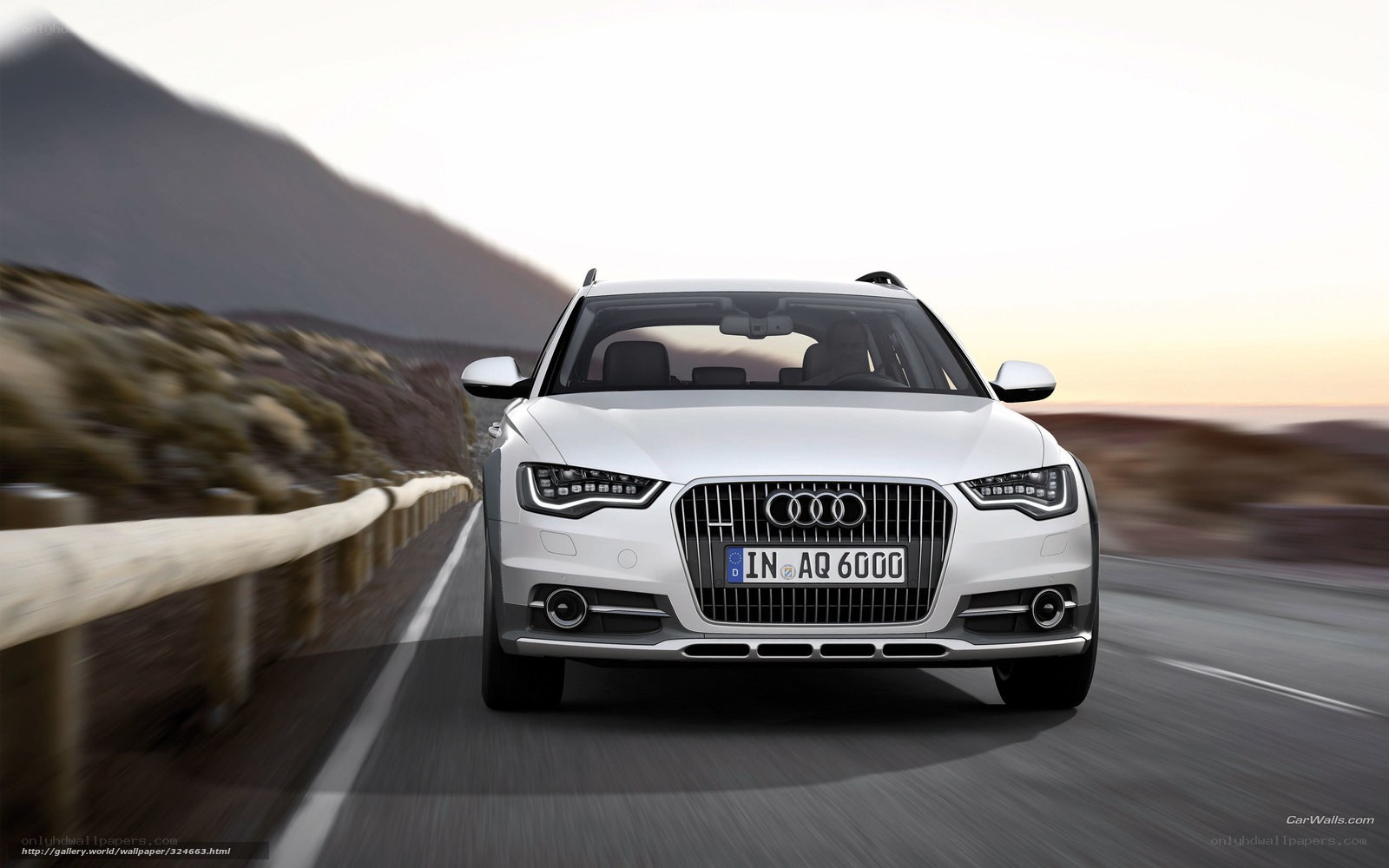 White Audi driving on mountain road