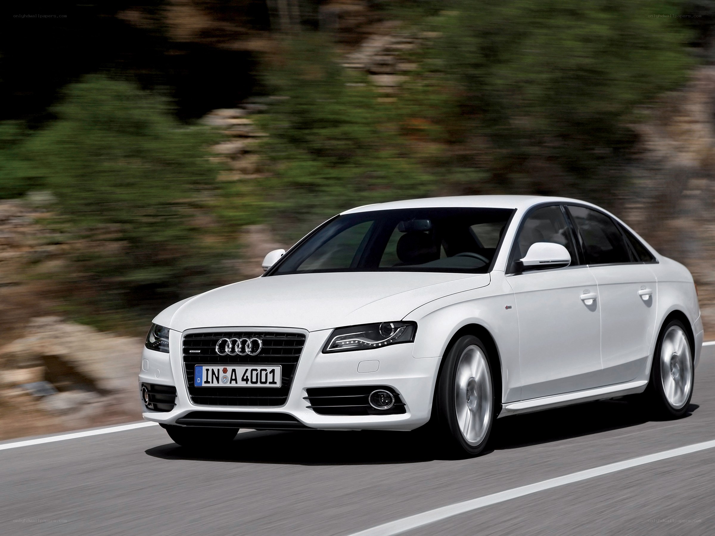 White Audi driving on road
