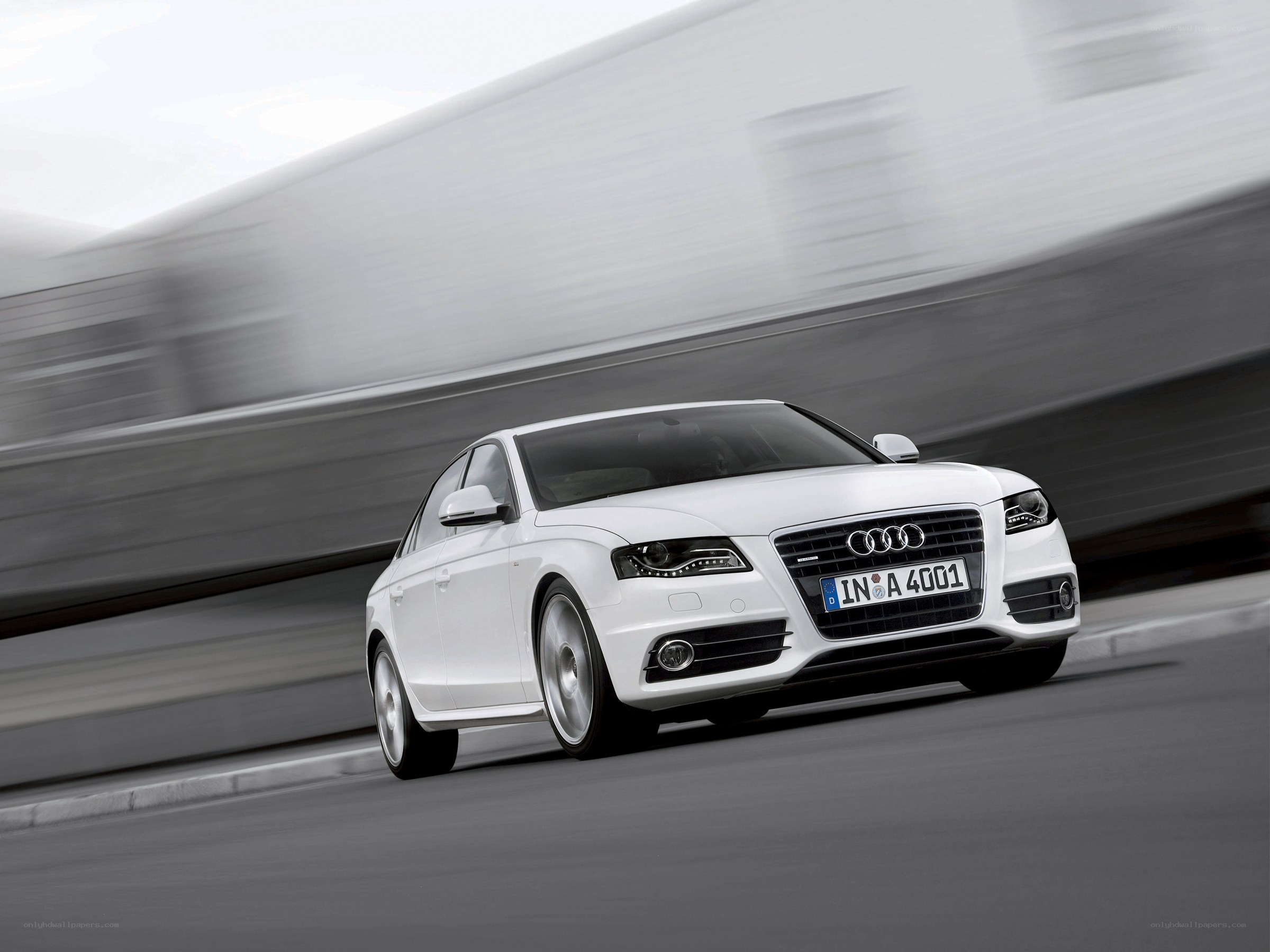 White Audi driving on road