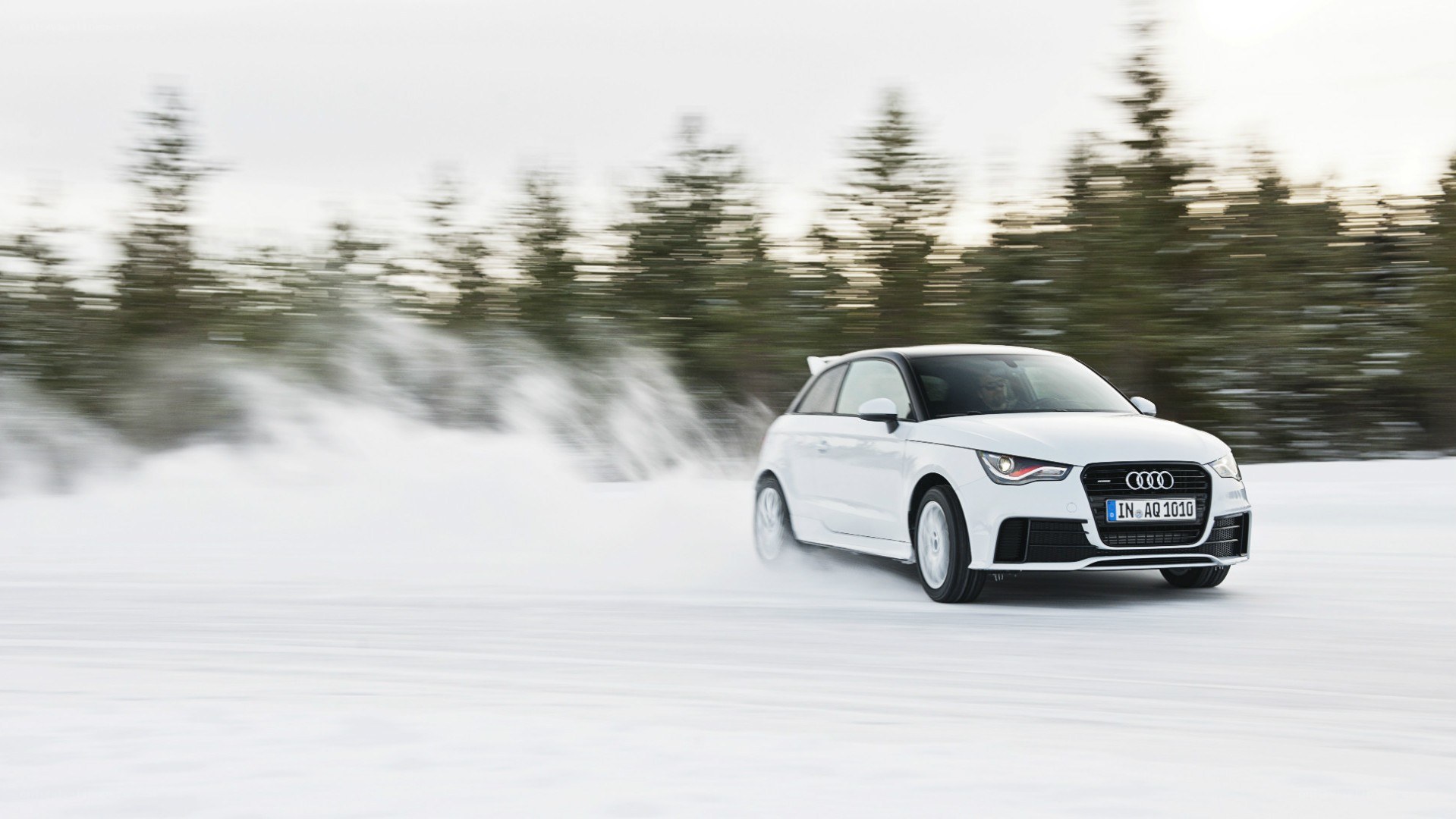 White Audi driving on snow