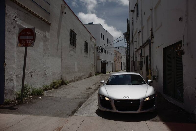 White Audi in a narrow alley