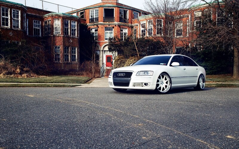 White Audi in front of brick building