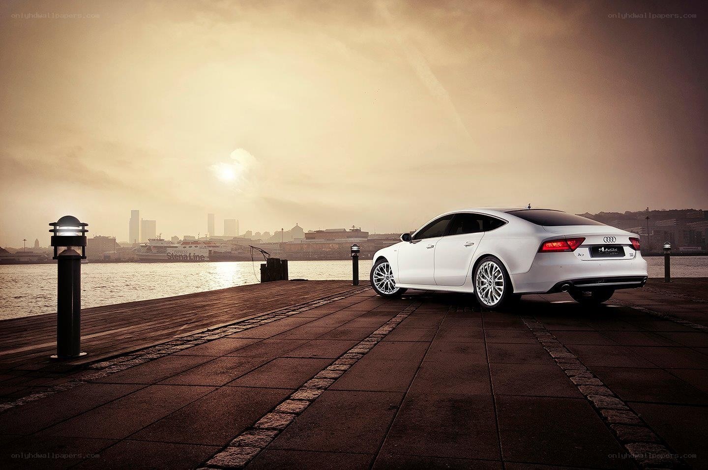 White Audi on a dock at sunset
