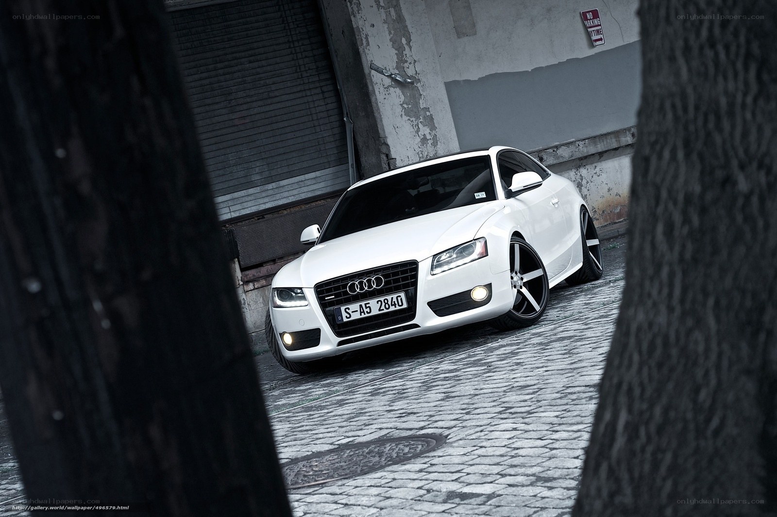White Audi on cobblestone street