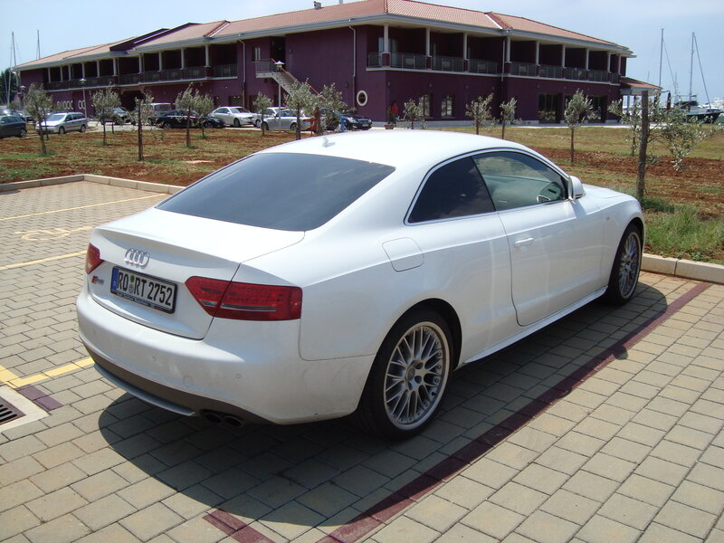White Audi parked in lot