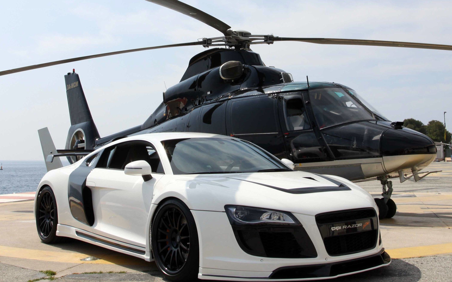 White Audi R8 and helicopter