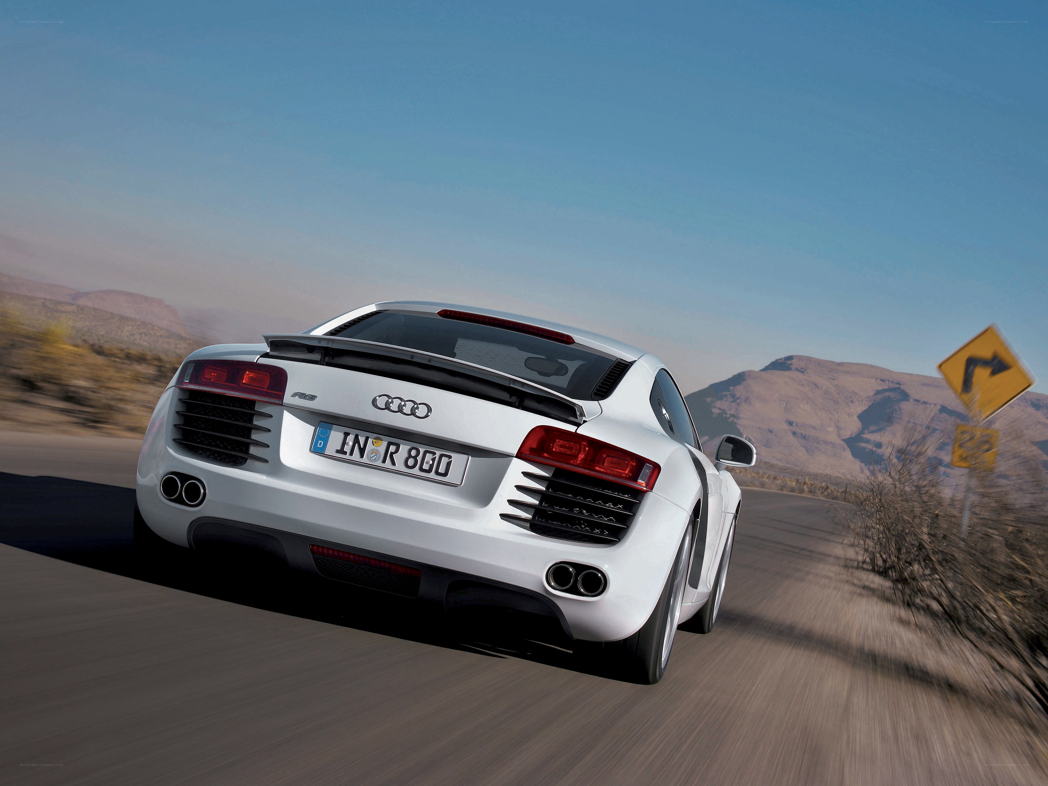 White Audi R8 driving on road