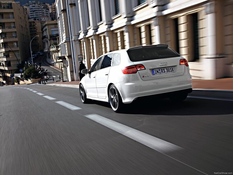 White Audi RS3 driving on city street