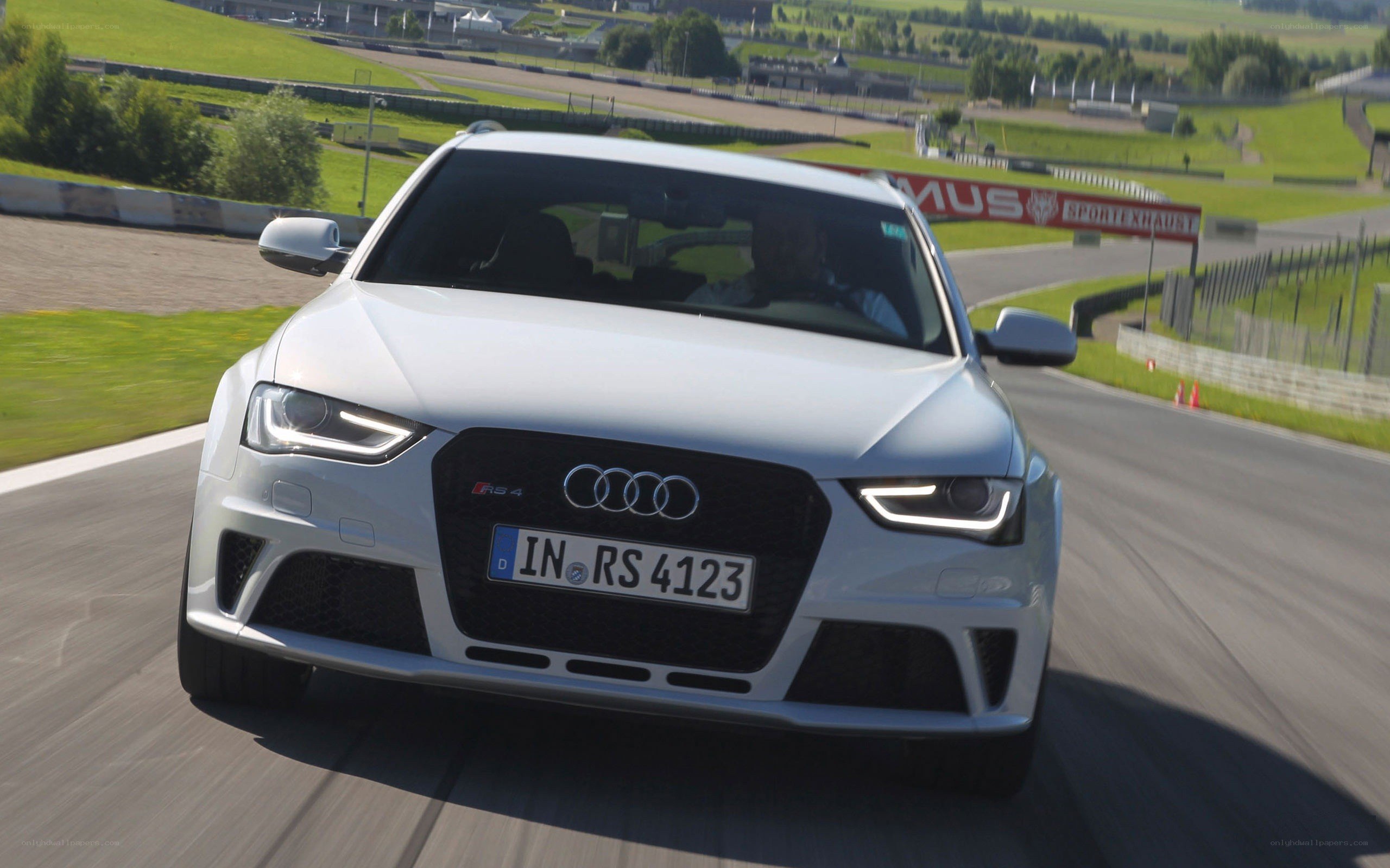 White Audi RS4 on a racetrack