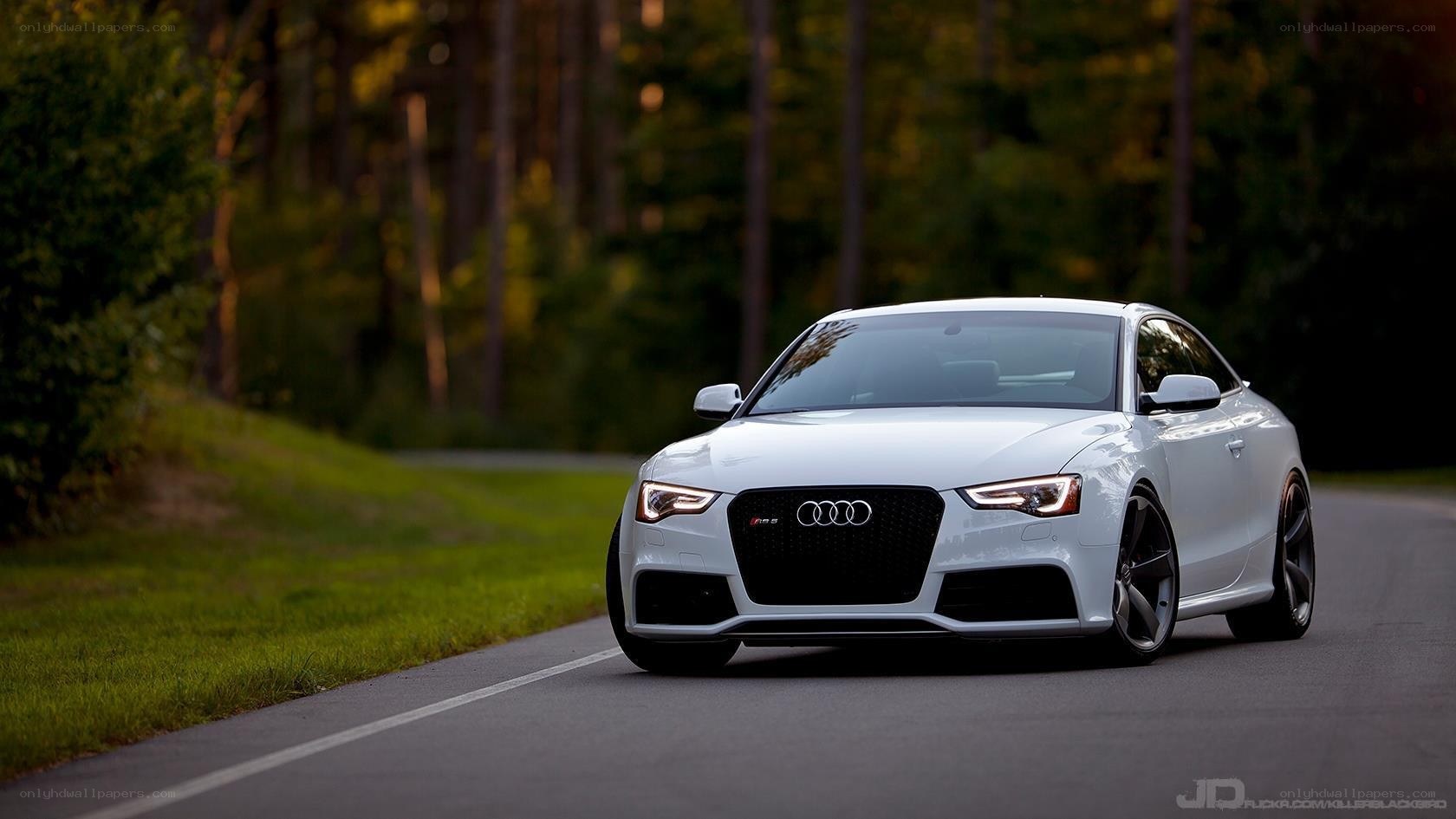 White Audi RS5 on a forest road