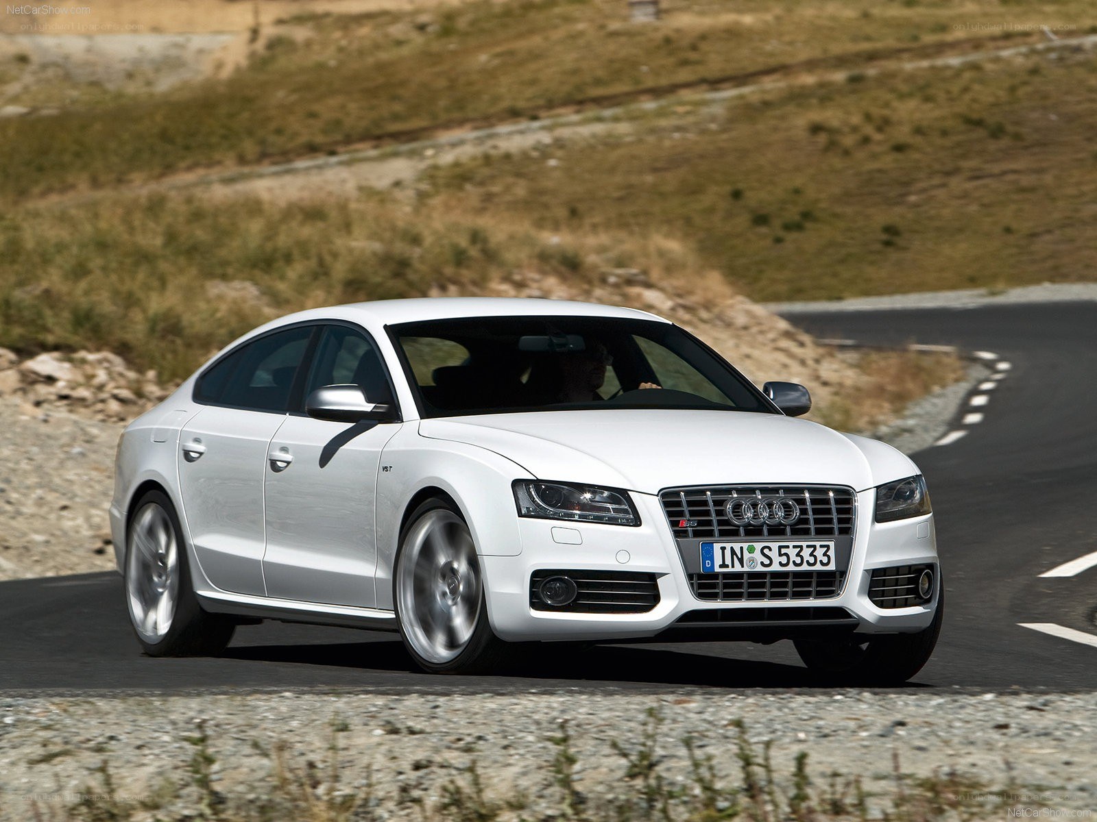 White Audi S5 driving on a road