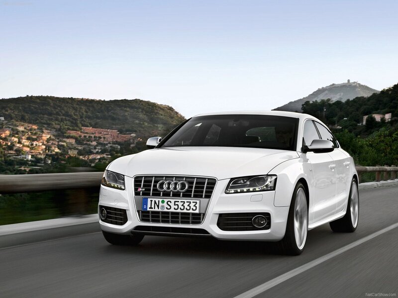 white audi s5 driving on road